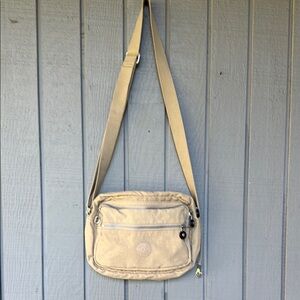 Kipling Tan Messenger Bag with Adjustable Strap and Durable Fabric